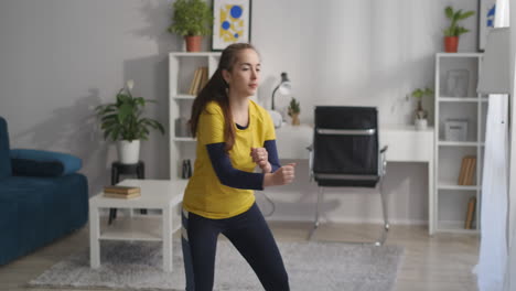 aerobic-training-at-home-teen-girl-is-doing-exercises-with-step-and-moving-hands-healthy-lifestyle-and-home-fitness-for-good-physical-condition